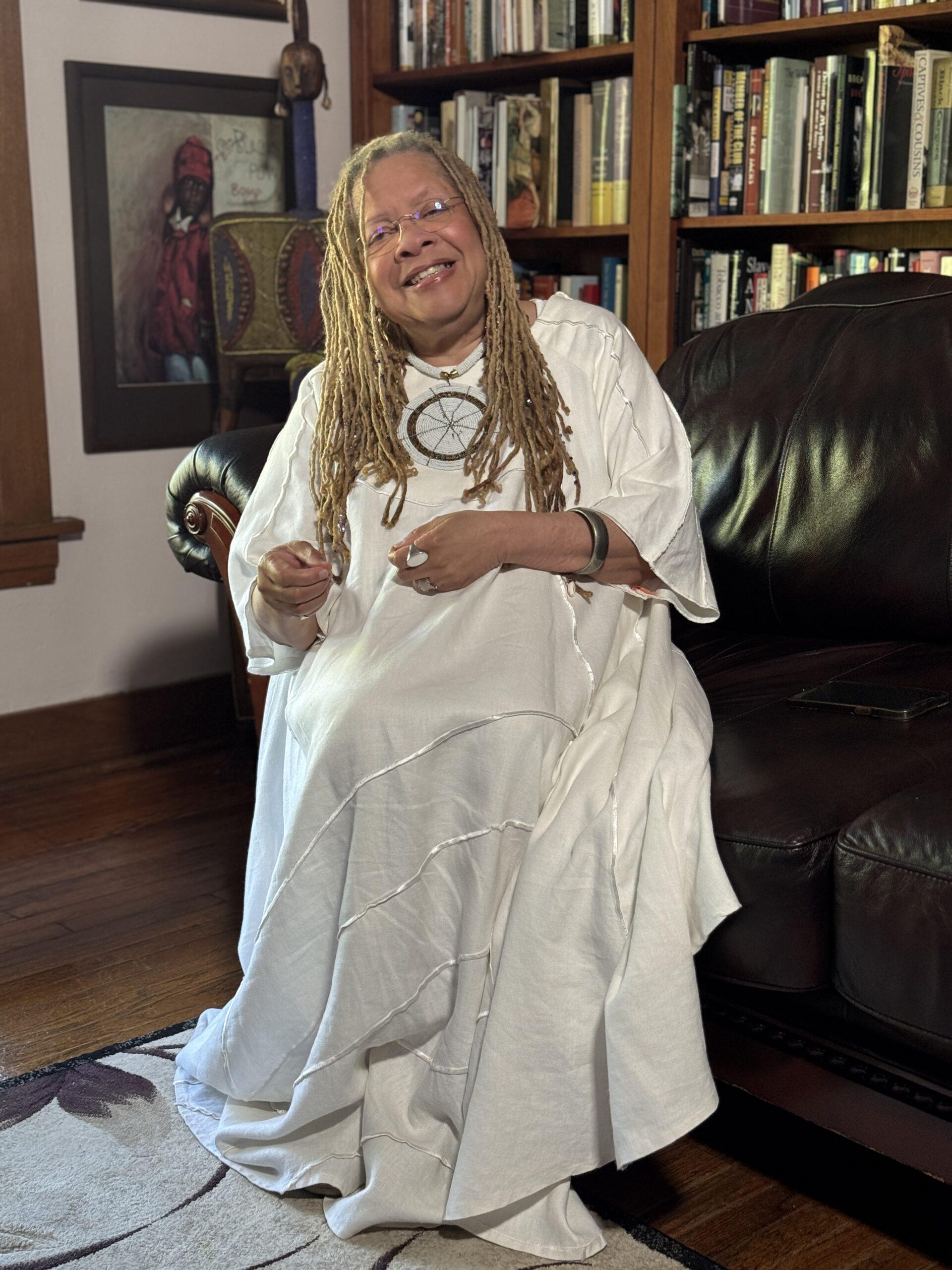 Dr. Gretta in white sitting home